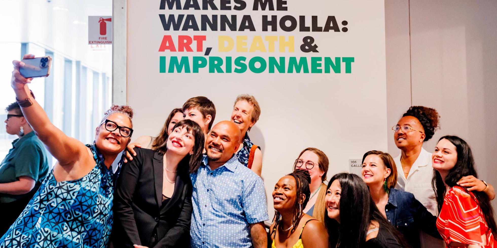 People taking a selfie at the "Makes Me Wanna Holla" exhibit