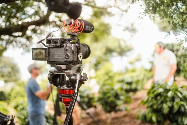 Camera on a tripod with two people in the background