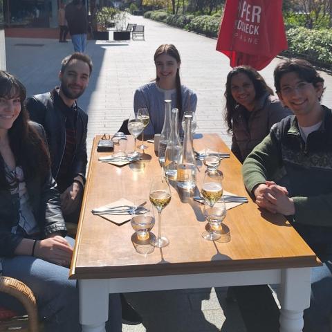 Anjli Parrin, Law School Students, and Undergraduate Interns Around a Table in Paris